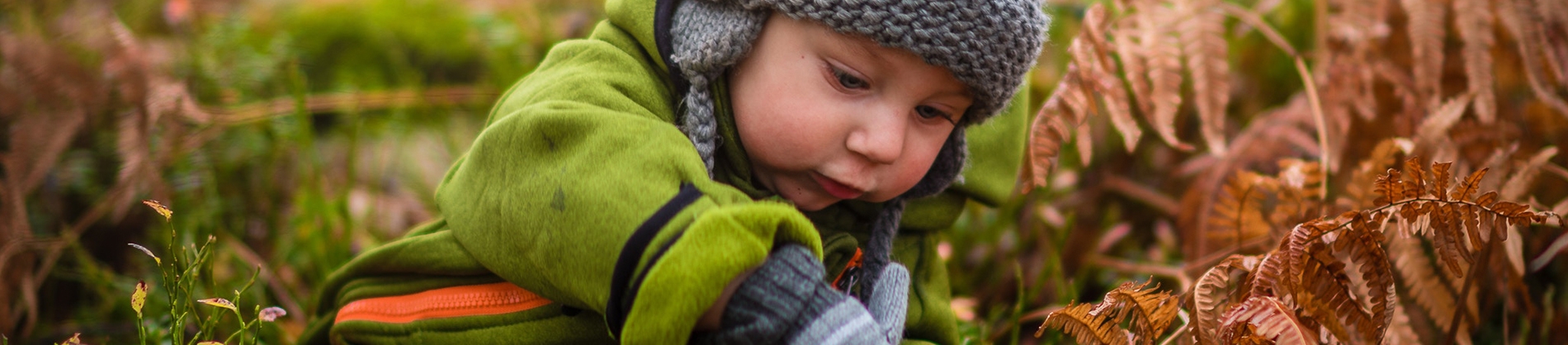 A young child playing in the grass
