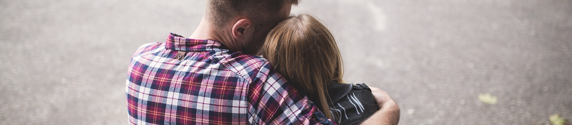 A man hugging and comforting a women A man hugging and comforting a women