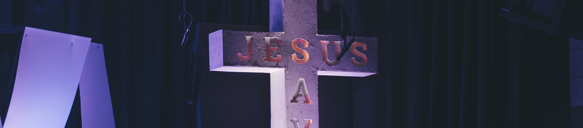 A concrete cross with Jesus engraved into it A concrete cross with Jesus engraved into it