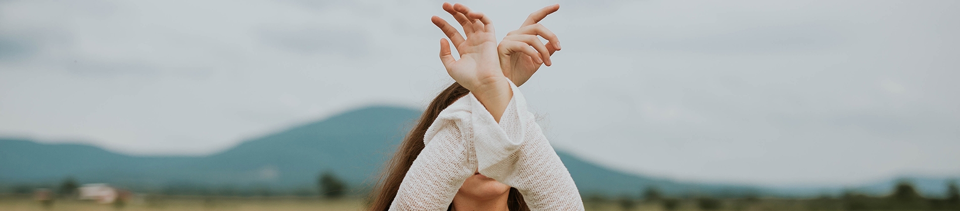 A women with her arms crossed up in the air A women with her arms crossed up in the air