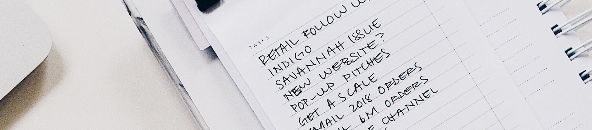 Tasks to do list with a list of tasks to do written in a notepad