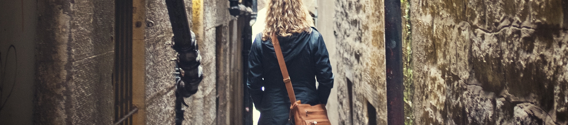 A women walking through an alley way A women walking through an alley way