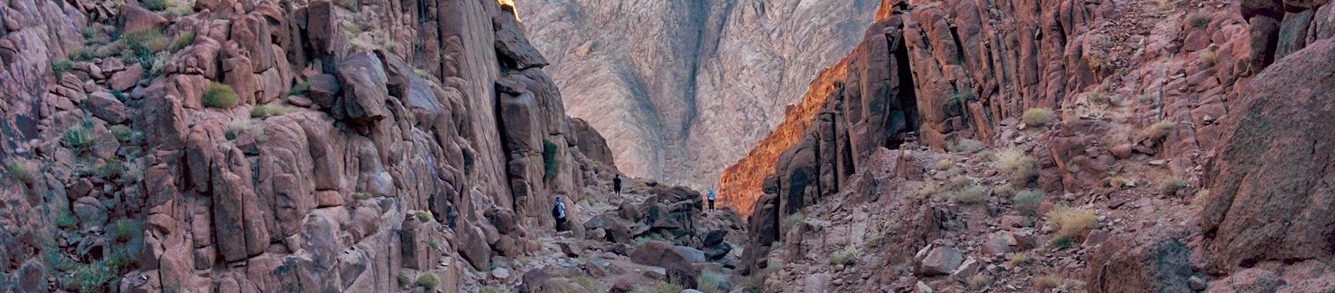 People climbing rocky mountains
