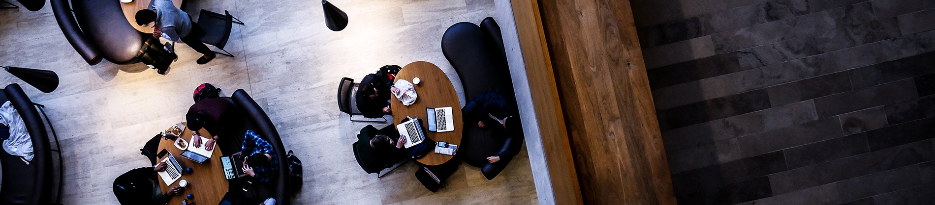 A birds eye view of people having business meetings on their laptops A birds eye view of people having business meetings on their laptops