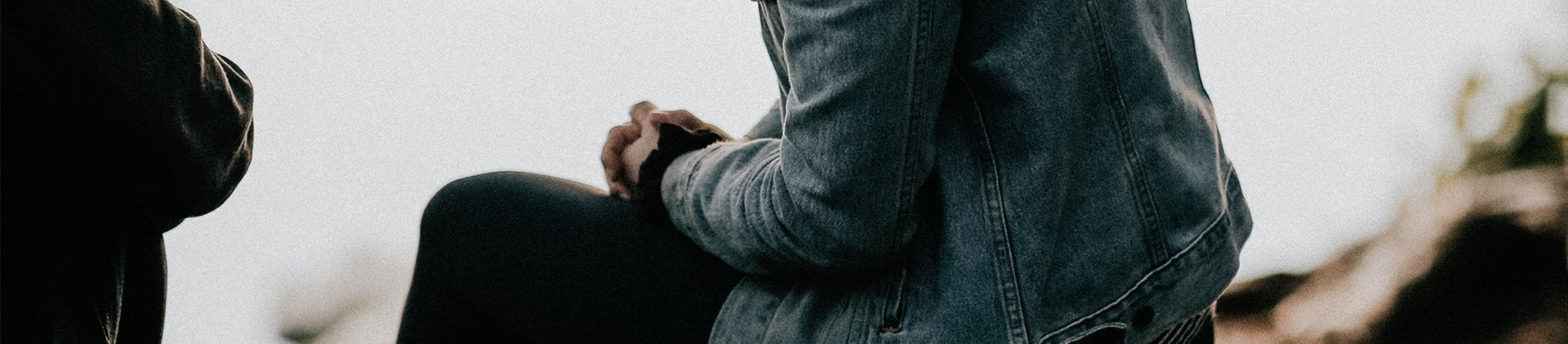 A women sat with her hands clasped in prayer A women sat with her hands clasped in prayer
