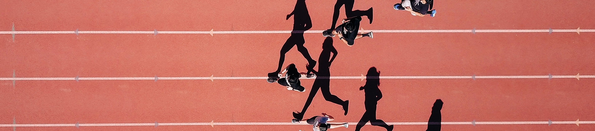 A group of people running on a running track A group of people running on a running track