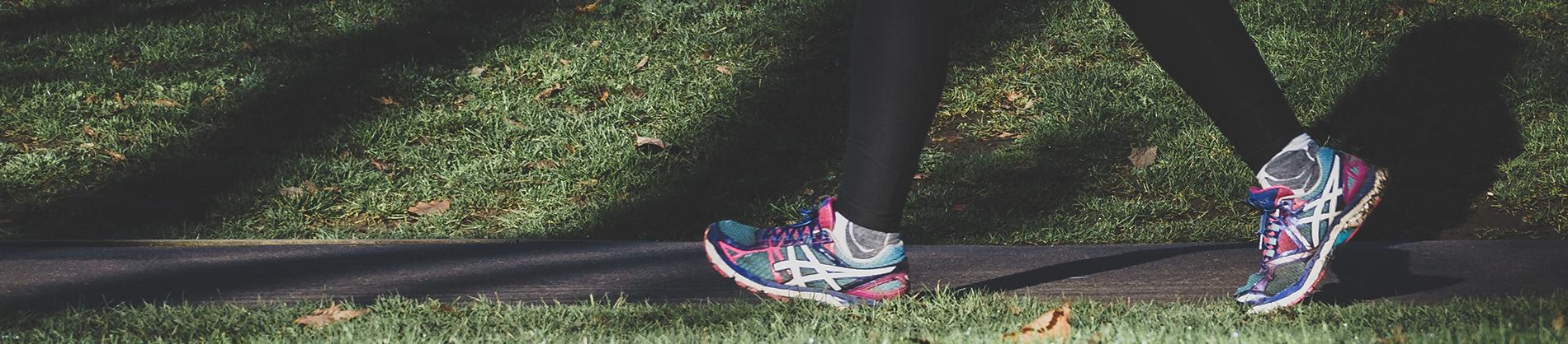 Women running down a path in running shoes