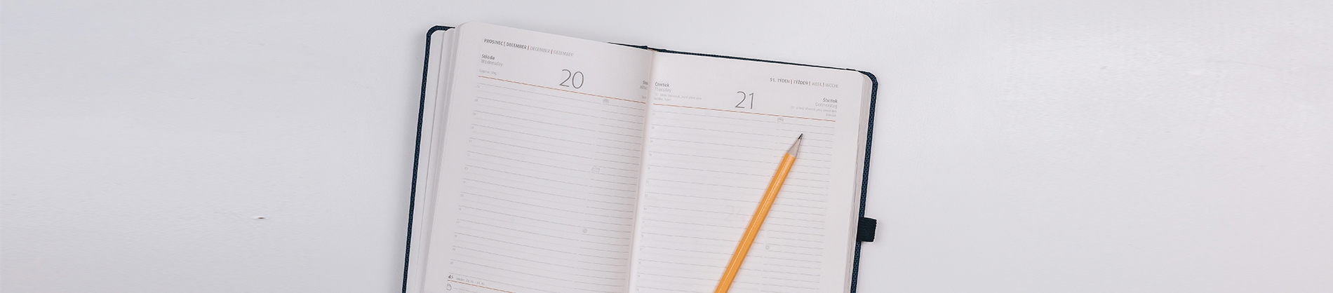 Open diary with a yellow pencil on top