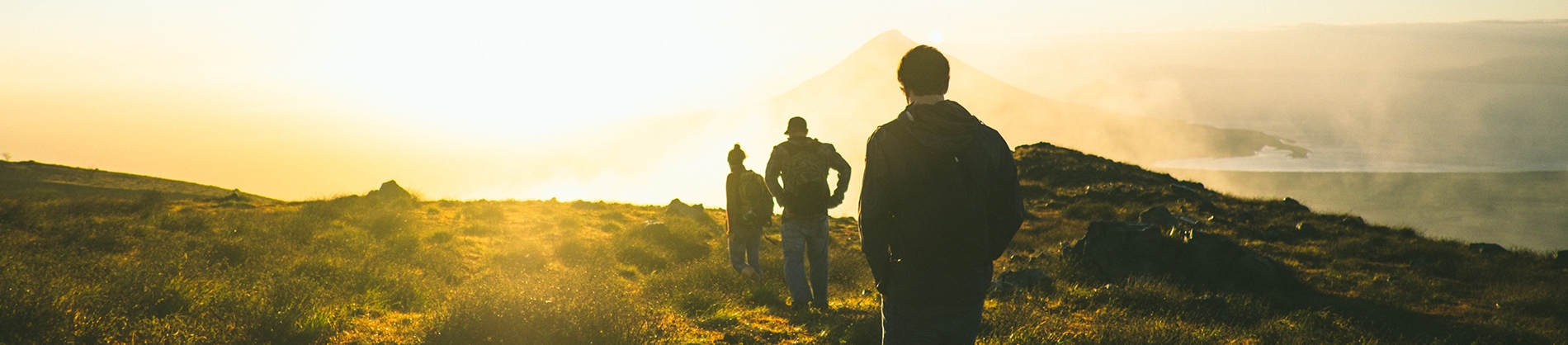 A group of men walking together across a cliff A group of men walking together across a cliff