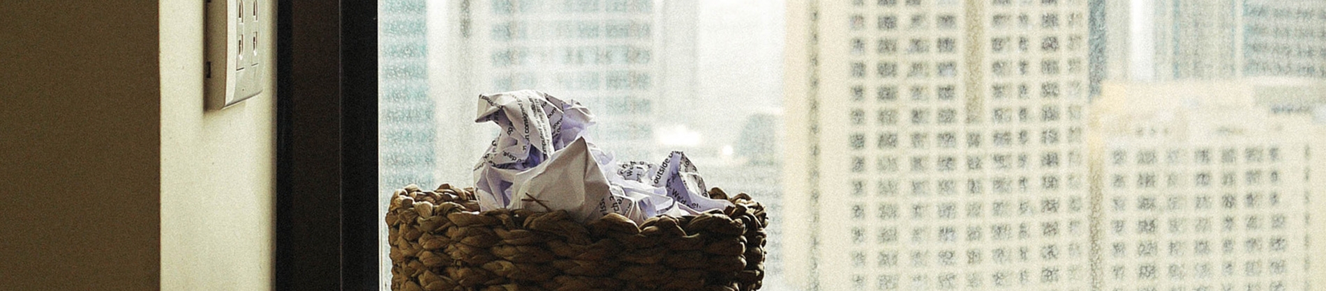 A bin with screwed up paper piled inside