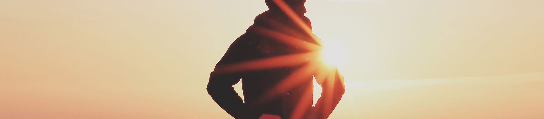 Man stood in front of a sunset