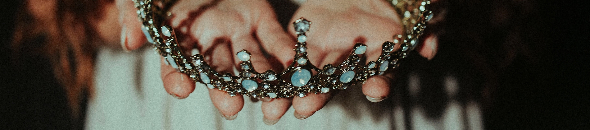 A women holding a crown made of blue jewels A women holding a crown made of blue jewels