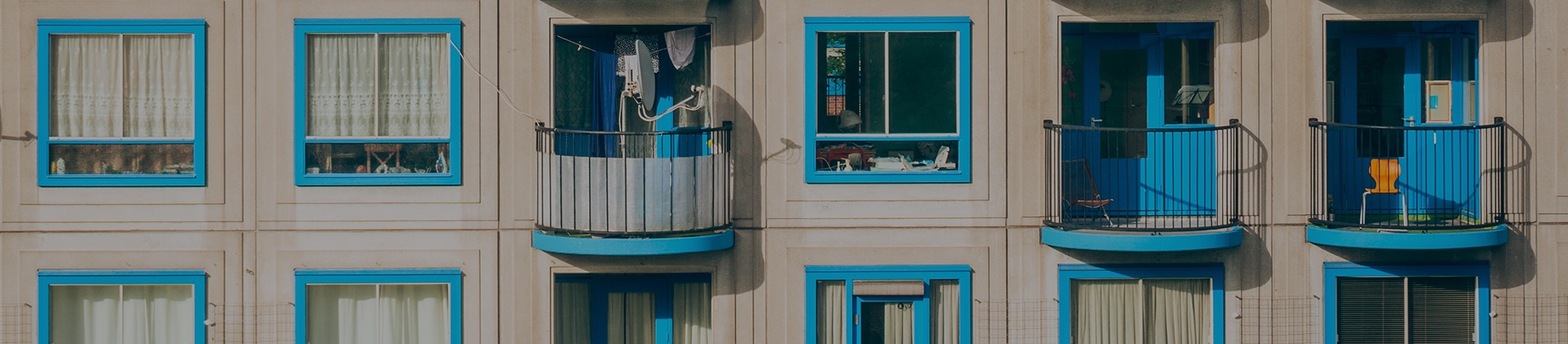 A block of flats with blue windows and balconies A block of flats with blue windows and balconies