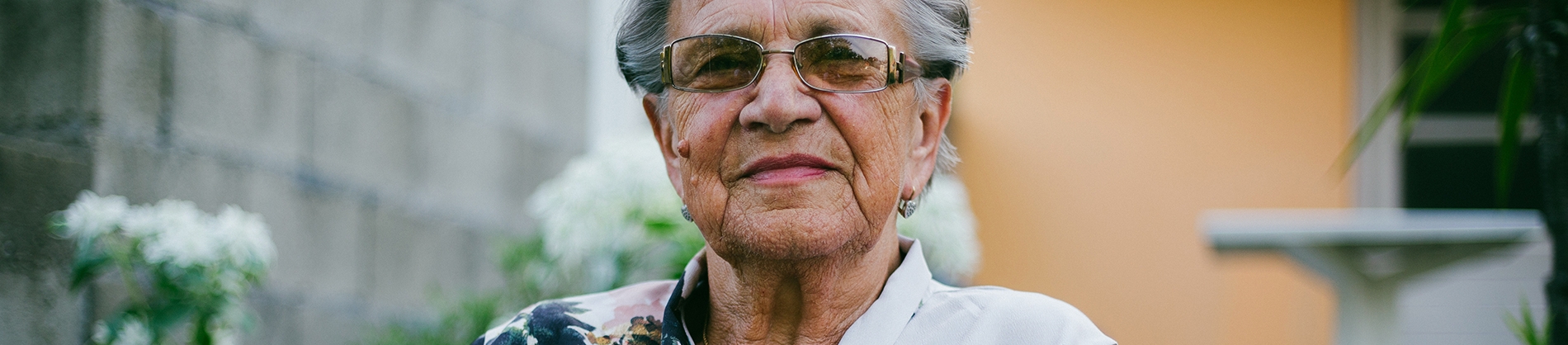 Elderly women sat outside her house