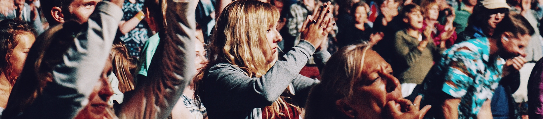 A crowd of people clapping and shouting A crowd of people clapping and shouting