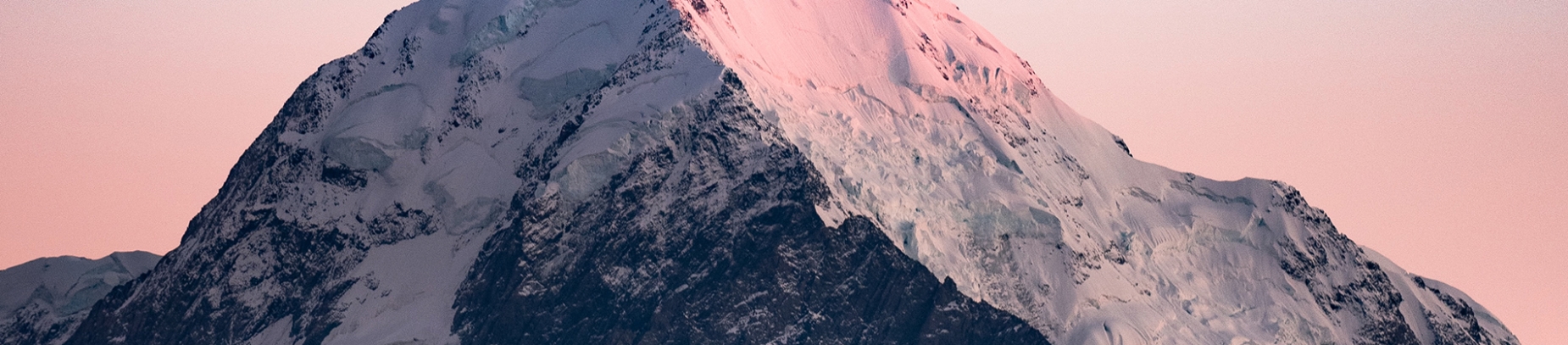A large mountain with the sunset shining on it A large mountain with the sunset shining on it
