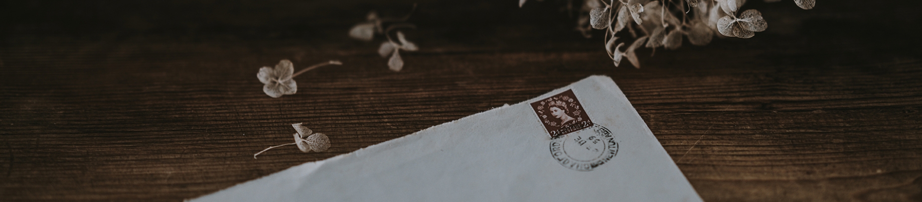 A stamped letter on a wooden table A stamped letter on a wooden table