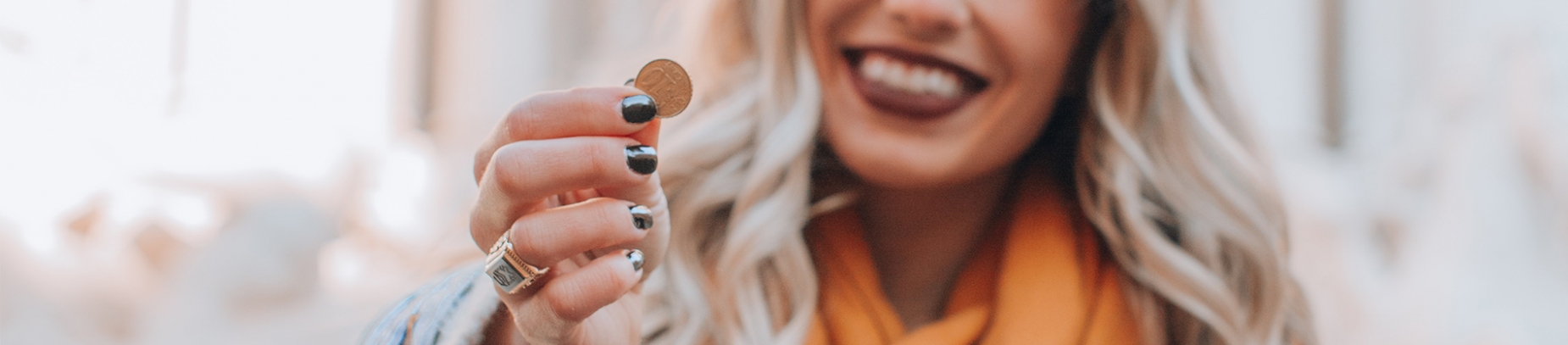 A women holding a copper coin A women holding a copper coin