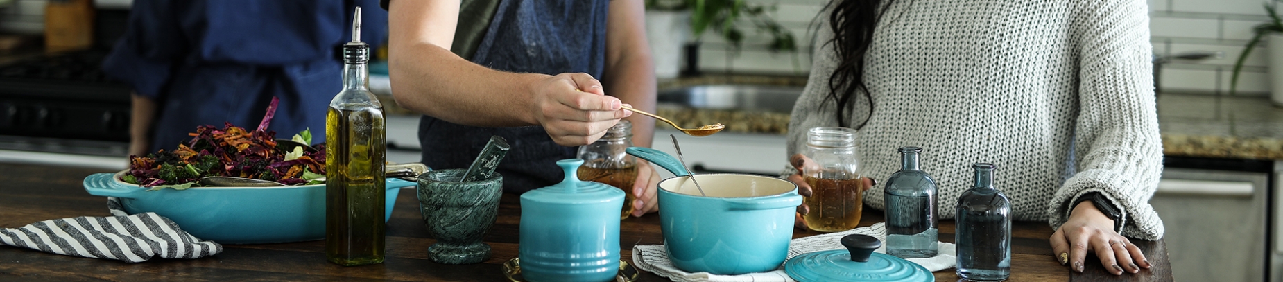 Two people cooking together on a island table Two people cooking together on a island table