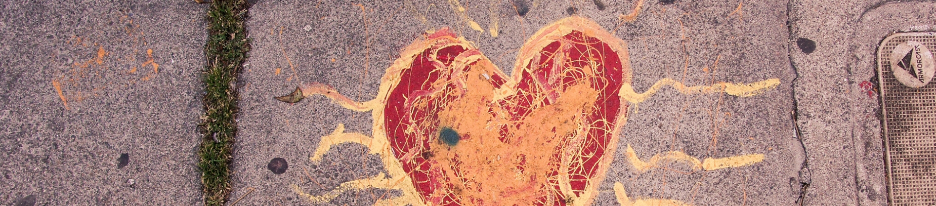A love heart drawn on pavement in red and yellow paint A love heart drawn on pavement in red and yellow paint