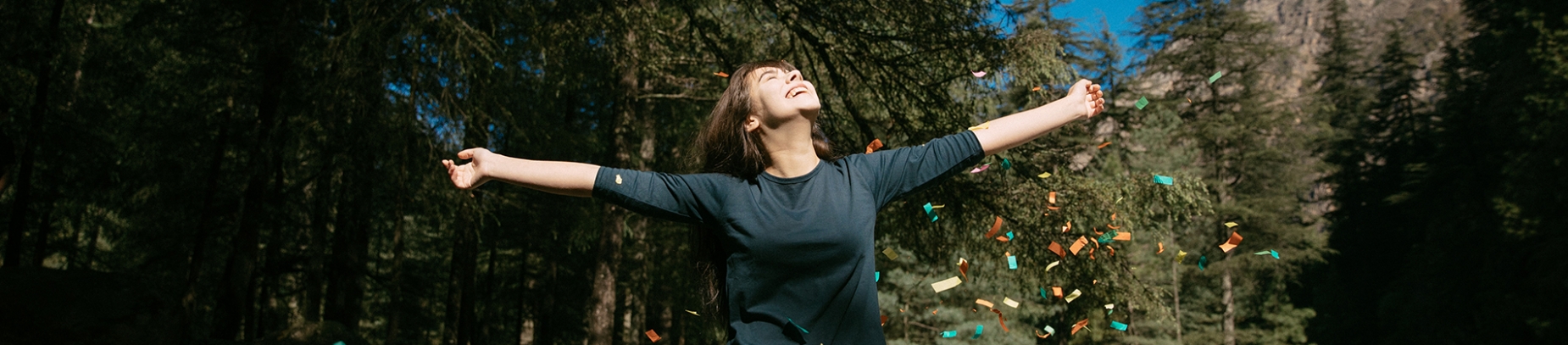 A women smiling with her arms open wide A women smiling with her arms open wide