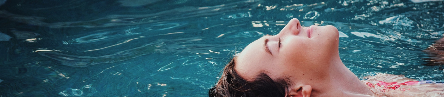 Women lying face up in a swimming pool