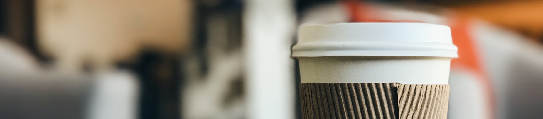 Coffee cup with a blurry scene in the background