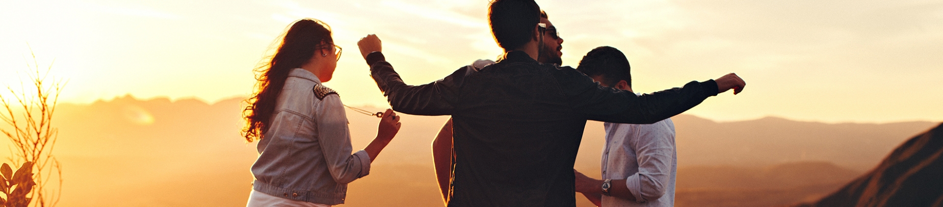 A group of friends on top of a hill talking A group of friends on top of a hill talking