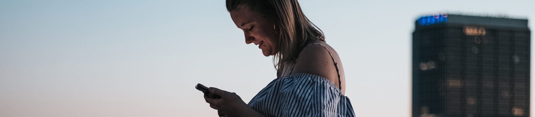 A women looking down at her phone A women looking down at her phone