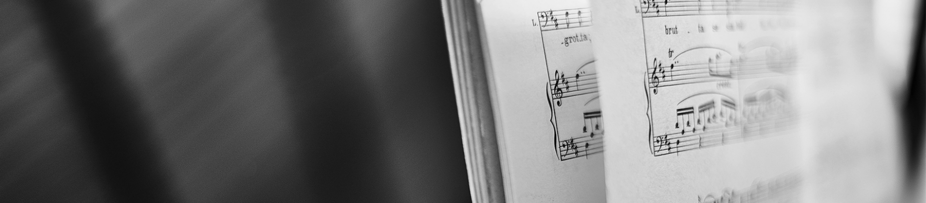 Sheet music stood up on a piano shelf