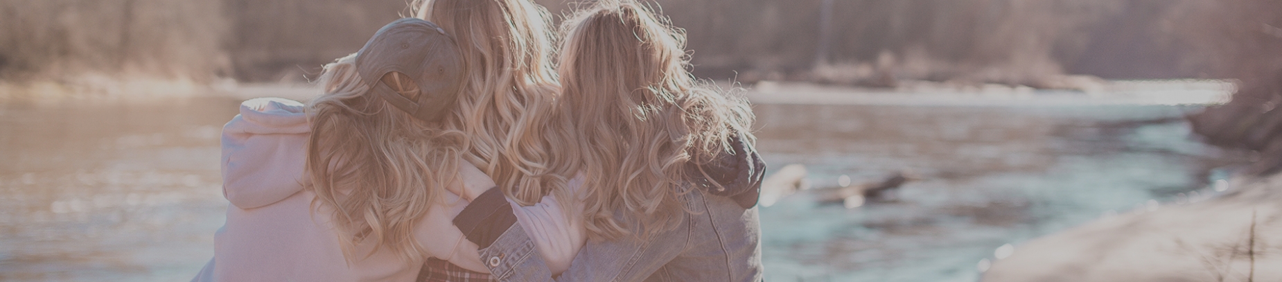 Three friends hugging beside the river Three friends hugging beside the river