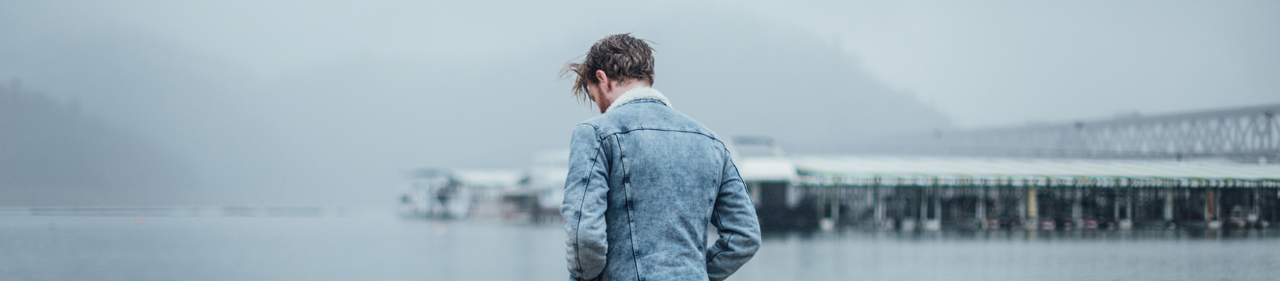 A guy looking down over the sea