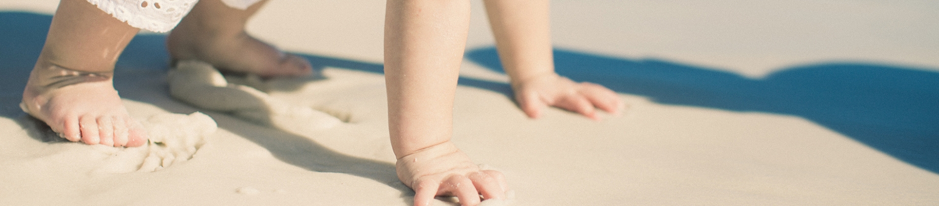 A child crawling in the sand