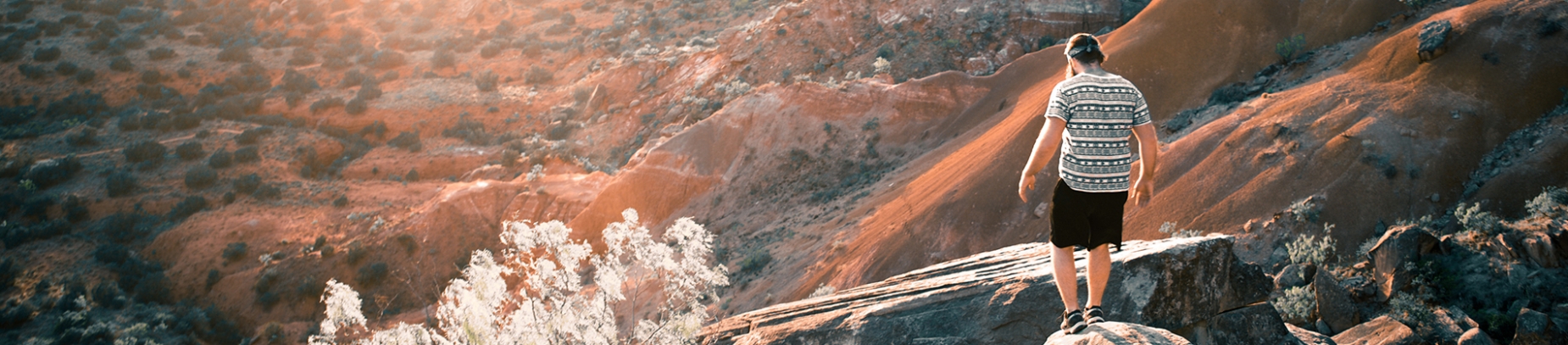 A man climbing over rocks down a hill A man climbing over rocks down a hill