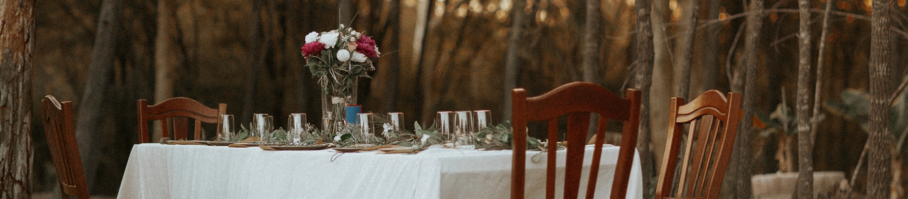 A ornate table set up in a forest A ornate table set up in a forest