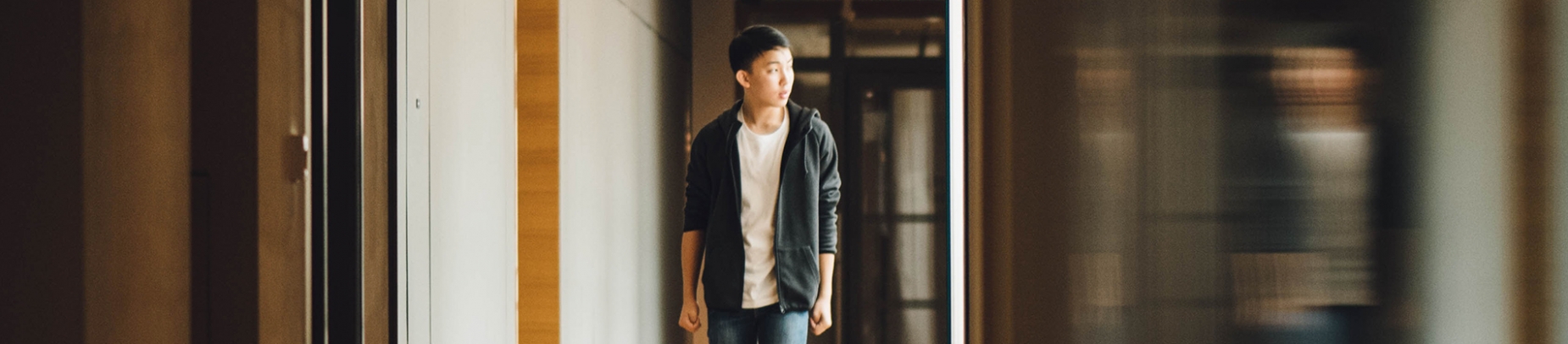 A guy walking down a corridor A guy walking down a corridor