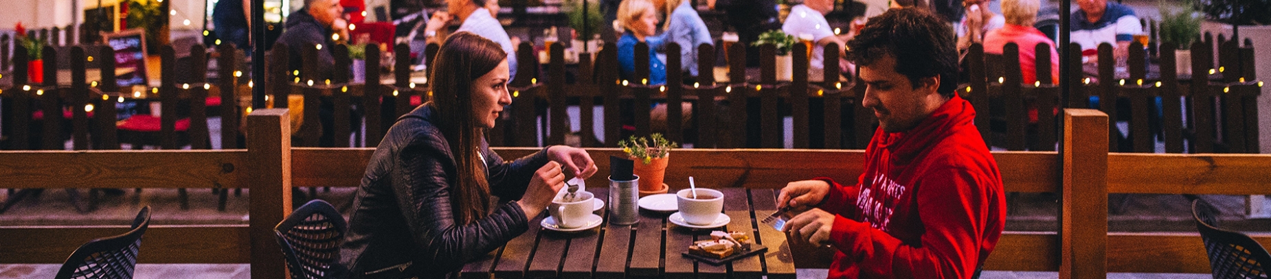 A man and women sat together at a outdoor restaurant A man and women sat together at a outdoor restaurant