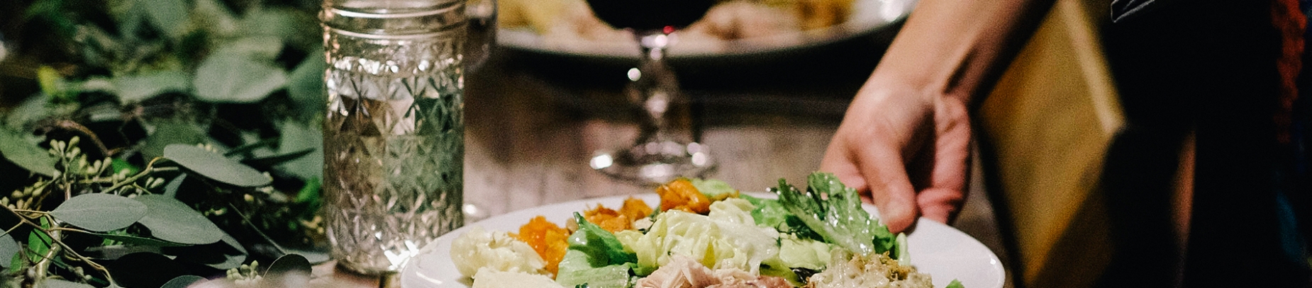 Someone putting a plate of food down onto a table Someone putting a plate of food down onto a table