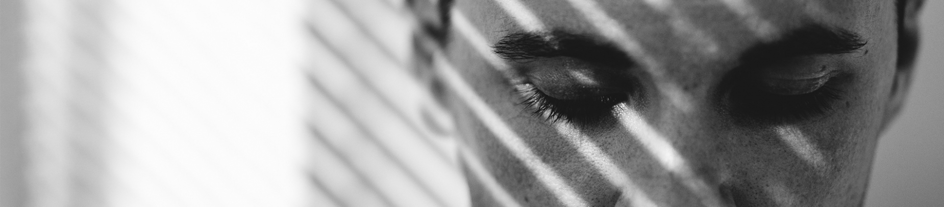 A black and white photo of a man looking down A black and white photo of a man looking down