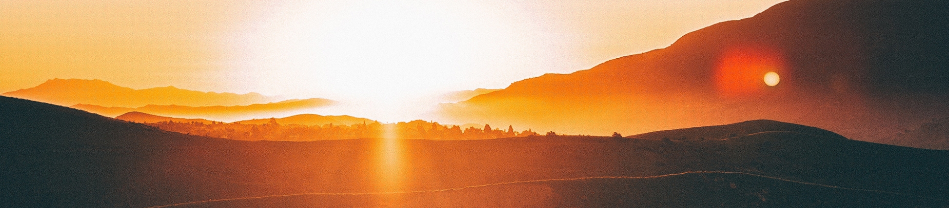 A sunrise over a mountain range A sunrise over a mountain range