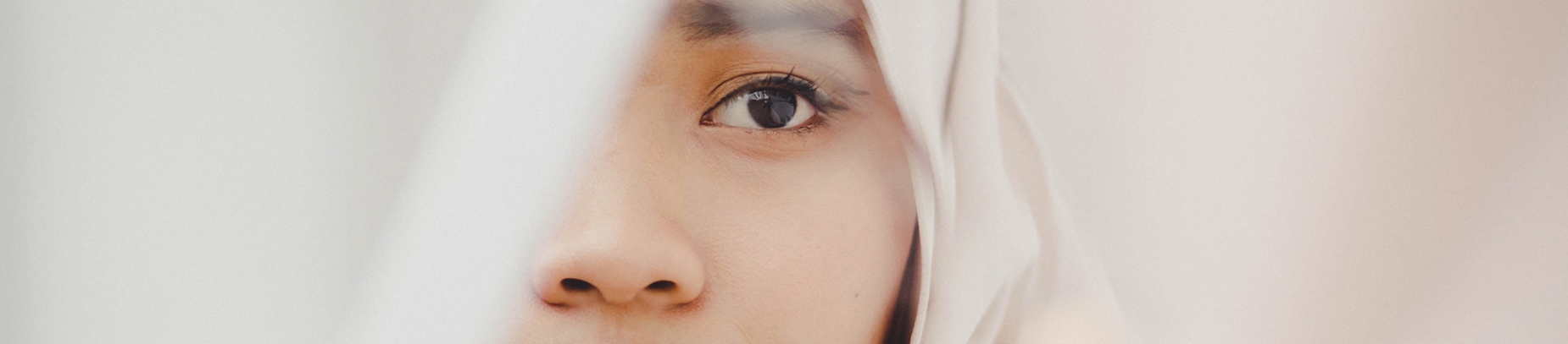 A close up of a girl looking in a mirror