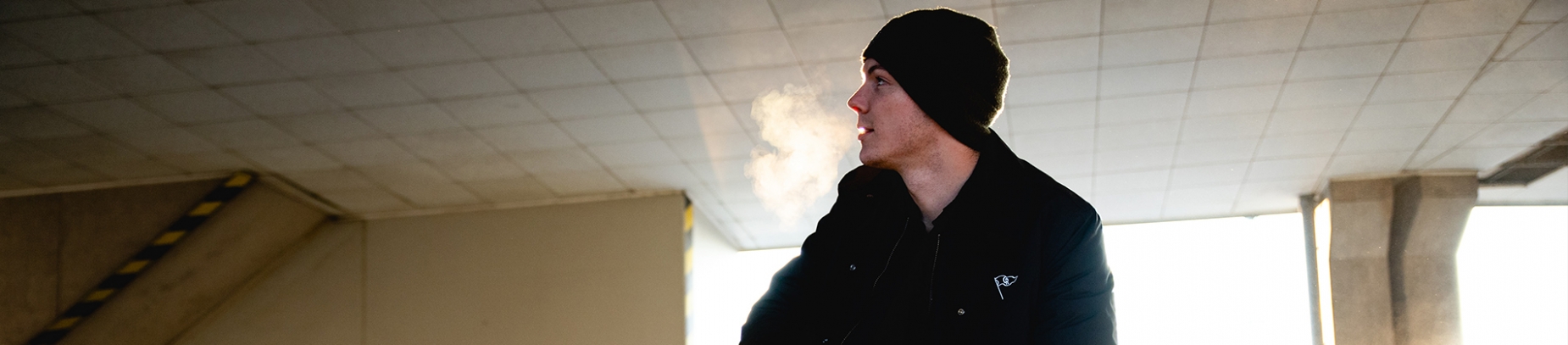 A man crouched down in a abandoned room A man crouched down in a abandoned room