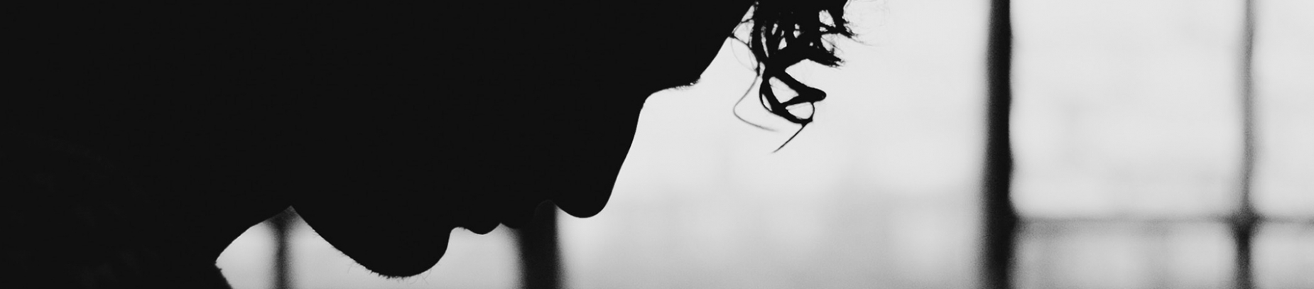 A silhouette of a man looking down A silhouette of a man looking down