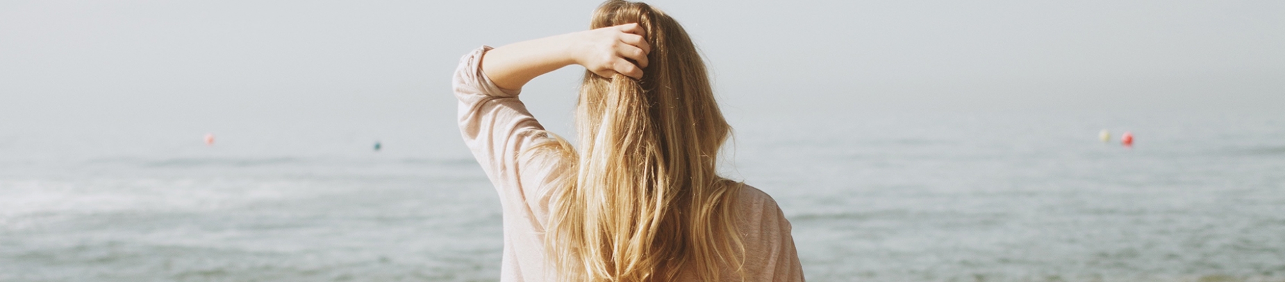 A women stood looking out to sea A women stood looking out to sea
