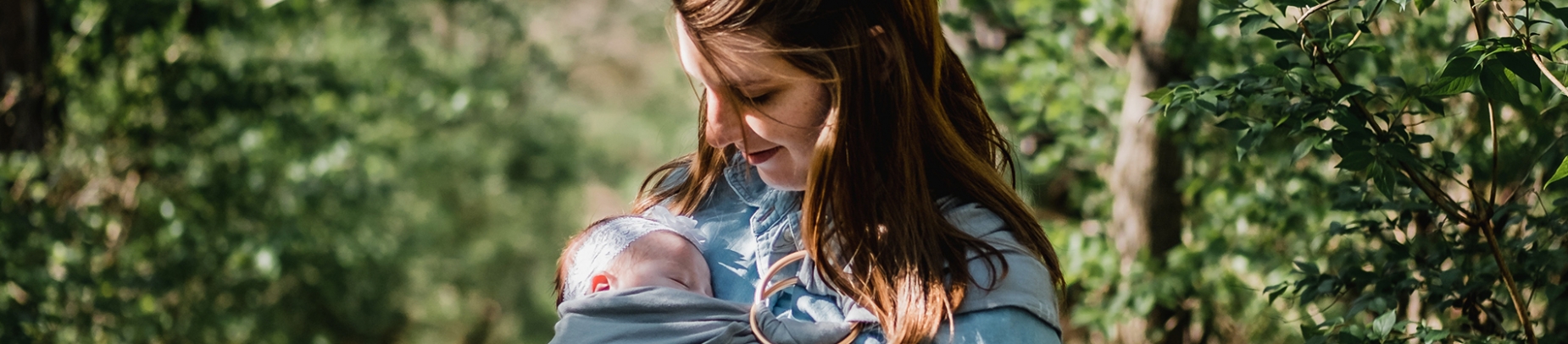 A women holding her baby in a forest A women holding her baby in a forest
