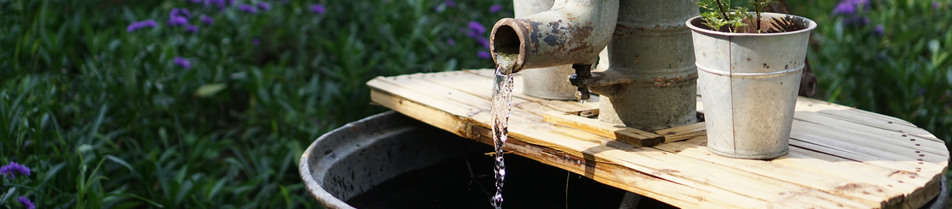A large outdoor tap pouring water A large outdoor tap pouring water