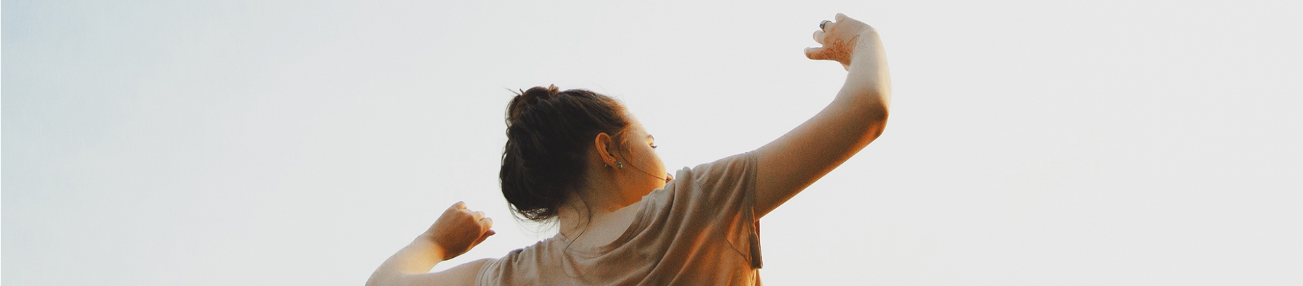 A women with her arms in the air towards the sky A women with her arms in the air towards the sky