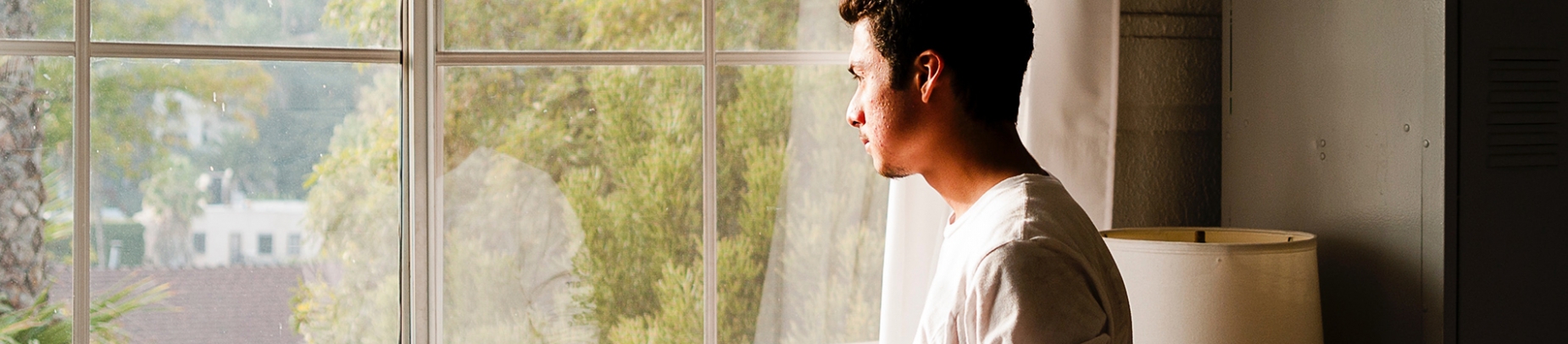 A man looking out of a window A man looking out of a window