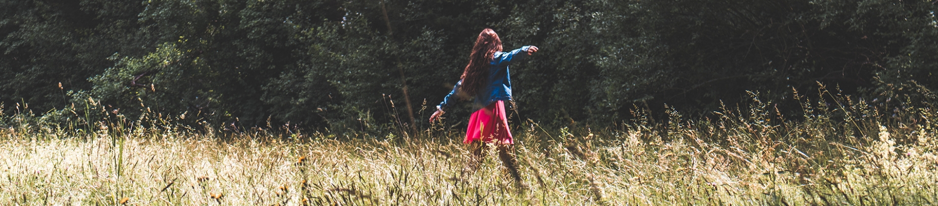 A women dancing in a field A women dancing in a field